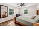 Cozy bedroom featuring hardwood floors, large windows, and natural light at 3540 Rugby Rd, Durham, NC 27707