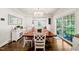 This dining room features hardwood floors, a large chandelier, a sideboard, and access to a backyard patio at 3540 Rugby Rd, Durham, NC 27707