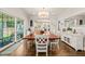 Elegant dining area with wood floors, chandelier, and large dining table next to sideboard at 3540 Rugby Rd, Durham, NC 27707