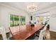 Bright dining room featuring a large table, chandelier, and sliding glass doors to the backyard at 3540 Rugby Rd, Durham, NC 27707