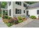 Charming white-painted home featuring black shutters, well-manicured landscaping, and a stone walkway to the front door at 3540 Rugby Rd, Durham, NC 27707