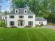 Attractive white two-story home featuring black shutters and well-manicured lawn at 3540 Rugby Rd, Durham, NC 27707