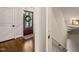 Charming foyer with dark wood front door with decorative glass, hardwood flooring, and paneled doors at 3540 Rugby Rd, Durham, NC 27707