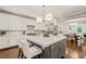 Spacious kitchen with white cabinets, marble countertops, and modern stainless steel appliances at 3540 Rugby Rd, Durham, NC 27707