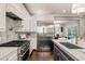 Well-appointed kitchen featuring stainless steel refrigerator and marble backsplash at 3540 Rugby Rd, Durham, NC 27707