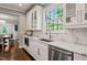 Bright kitchen showcasing white cabinetry, stainless steel appliances, and marble countertops at 3540 Rugby Rd, Durham, NC 27707