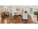 Open-concept living room with hardwood floors, a fireplace, comfortable sofas, and access to the dining area at 3540 Rugby Rd, Durham, NC 27707