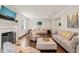 Bright living room featuring a fireplace, recessed lighting, hardwood floors, and neutral colored sofas at 3540 Rugby Rd, Durham, NC 27707