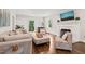 Spacious living room with hardwood floors, neutral colored sofas, and a fireplace at 3540 Rugby Rd, Durham, NC 27707
