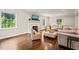 This living room features hardwood floors, a fireplace, neutral colored sofas, and windows that provide natural light at 3540 Rugby Rd, Durham, NC 27707