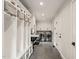 Functional mud room with built-in cubbies, black sink, and laundry area at 3540 Rugby Rd, Durham, NC 27707
