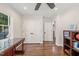 Bright office featuring hardwood floors, a ceiling fan, storage, and multiple access doors at 3540 Rugby Rd, Durham, NC 27707