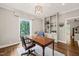 Bright office with hardwood floors, a desk, a chair, a rug, and built in shelving at 3540 Rugby Rd, Durham, NC 27707