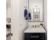 Elegant powder room featuring black vanity, marble countertop, and stylish mirror at 3540 Rugby Rd, Durham, NC 27707