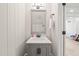 Nicely updated powder room with gray vanity, white countertop, modern faucet, and beadboard accent at 3540 Rugby Rd, Durham, NC 27707