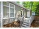 Charming home's backyard featuring a patio, exterior lighting, and mature trees for shade at 3616 Culater Ct, Raleigh, NC 27616