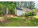 Beautiful backyard with lush green grass, metal raised garden beds, and mature trees at 3616 Culater Ct, Raleigh, NC 27616
