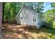 Backyard of the home, featuring mature trees and manicured shrubbery at 3616 Culater Ct, Raleigh, NC 27616