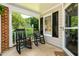 Inviting front porch with black rocking chairs, offering a relaxing outdoor space with natural light at 3616 Culater Ct, Raleigh, NC 27616