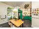Bright kitchen with green cabinets, stainless appliances, and dining area with hardwood floors and lots of natural light at 3616 Culater Ct, Raleigh, NC 27616