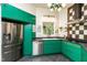 Modern kitchen features stainless steel appliances, emerald cabinets, and black countertops at 3616 Culater Ct, Raleigh, NC 27616