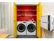 Convenient laundry room closet with modern LG washer and dryer, and bold yellow doors at 3616 Culater Ct, Raleigh, NC 27616