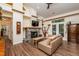 Bright living room with high ceilings, exposed beams, a stone fireplace, and unique wall decorations at 3616 Culater Ct, Raleigh, NC 27616
