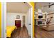 Open concept living room boasts a stone fireplace, exposed beams, and hardwood flooring at 3616 Culater Ct, Raleigh, NC 27616