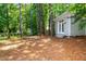 Outbuilding with double doors nestled amongst mature shade trees at 3616 Culater Ct, Raleigh, NC 27616