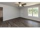 Bright bedroom featuring a ceiling fan, natural light, and wood-look floors at 381 Gray Ghost Ln, Benson, NC 27504