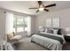 Staged bedroom with stylish decor, large window, and cozy ambiance at 381 Gray Ghost Ln, Benson, NC 27504