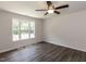 This bedroom has vinyl floors and a large window at 381 Gray Ghost Ln, Benson, NC 27504