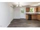 Open dining area with sleek laminate flooring and backyard access at 381 Gray Ghost Ln, Benson, NC 27504