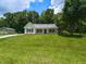 Adorable one-story home with a lush front lawn, showcasing a peaceful setting at 381 Gray Ghost Ln, Benson, NC 27504