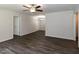 Open-concept living space with ceiling fan, closet, and stylish wood flooring at 381 Gray Ghost Ln, Benson, NC 27504