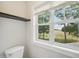 Bright bathroom window showcasing the view of the surrounding yard at 3901 Yates Mill Trl, Raleigh, NC 27606