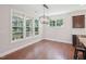 Bright dining area with hardwood floors, stylish chandelier, large windows, and views of the backyard at 3901 Yates Mill Trl, Raleigh, NC 27606