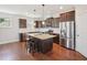 Beautiful kitchen featuring granite countertops, stainless steel appliances, a large island, and hardwood floors at 3901 Yates Mill Trl, Raleigh, NC 27606