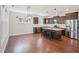 Spacious kitchen with a large island, stainless steel appliances, hardwood floors, and modern lighting fixtures at 3901 Yates Mill Trl, Raleigh, NC 27606