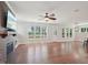 Spacious living room with hardwood floors, a fireplace, and large windows overlooking the yard at 3901 Yates Mill Trl, Raleigh, NC 27606