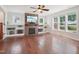Cozy living room with a brick fireplace, built-in shelving, and hardwood floors at 3901 Yates Mill Trl, Raleigh, NC 27606