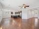 Open-concept living room with hardwood floors, modern ceiling fan, and an island kitchen with stainless steel appliances at 3901 Yates Mill Trl, Raleigh, NC 27606