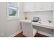 Bright office with white built-in desk, drawers, cabinets, and a window with neighborhood views at 3901 Yates Mill Trl, Raleigh, NC 27606