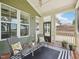 Inviting screened porch with a ceiling fan, wood floors, and comfortable seating area at 3901 Yates Mill Trl, Raleigh, NC 27606