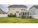Exterior view of the rear of the home with a screened in porch and a well maintained lawn at 40 Two Creeks Loop, Chapel Hill, NC 27517