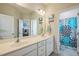Bright bathroom features double sinks with a decorative shower curtain and ample lighting at 40 Two Creeks Loop, Chapel Hill, NC 27517