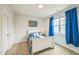 Cozy bedroom featuring a white bed frame, bright blue curtains and bedding, and a matching bedside table at 40 Two Creeks Loop, Chapel Hill, NC 27517