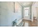 Inviting entryway with a decorative light fixture, front door with glass and a comfortable bench with pillow at 40 Two Creeks Loop, Chapel Hill, NC 27517