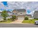 Charming two-story home with stone accents, a well-manicured lawn and attached two-car garage at 40 Two Creeks Loop, Chapel Hill, NC 27517