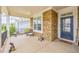 Charming front porch with stone accents, seating, and a welcoming blue front door at 40 Two Creeks Loop, Chapel Hill, NC 27517